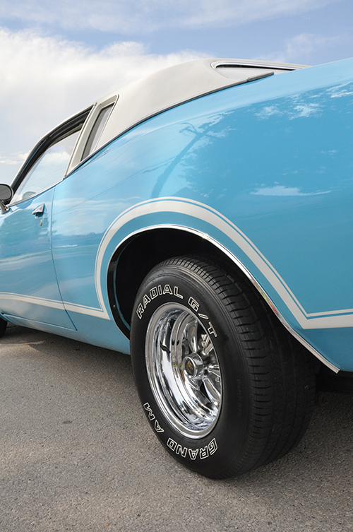 Classic baby blue car with exterior detail.